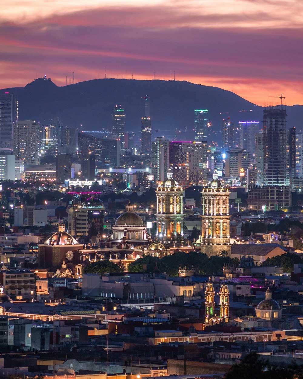 Foto de Puebla al atardecer con edificios de fondo.